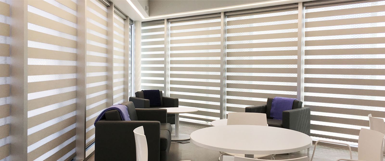 Cream dual shades fitted around a bright seating area